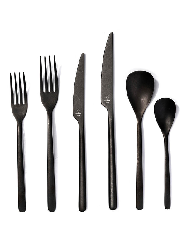Six pieces of matte black cutlery—two forks, two knives, a tablespoon, and a teaspoon—are arranged side by side on a white background.