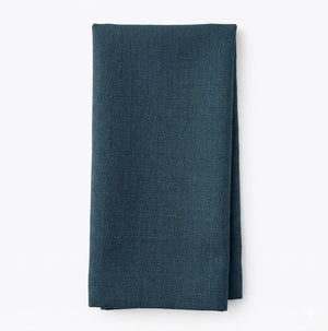 A neatly folded Amelia Blue Linen napkin on a plain white background—perfect for adding an elegant fabric touch to any event.