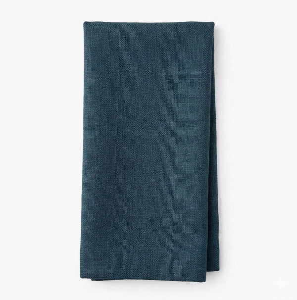 A neatly folded Amelia Blue Linen napkin on a plain white background—perfect for adding an elegant fabric touch to any event.