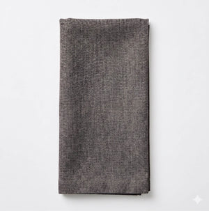 The Amelia Grey Linen napkin, featuring a textured dark gray fabric, is neatly folded and displayed on a plain white background—an ideal elegant accent for any event setting.