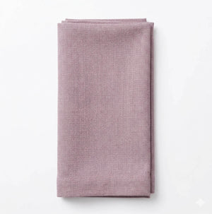 A neatly folded Amelia Old Pink Linen napkin with a refined texture is placed on a plain white background.