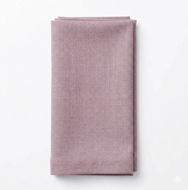 A neatly folded Amelia Old Pink Linen napkin with a refined texture is placed on a plain white background.