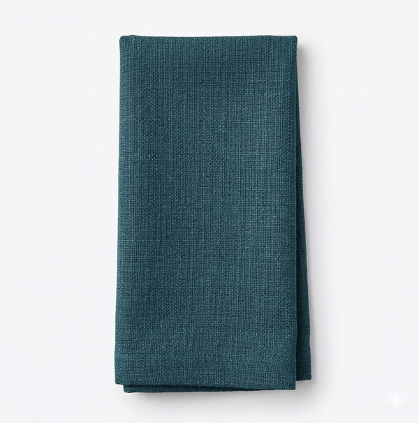 A neatly folded Amelia Turquoise Linen napkin, made from elegant fabric, is displayed against a plain white background.