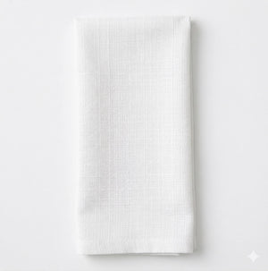 The Amelia White Linen napkin features elegant white linen with a subtle textured pattern, neatly folded on a plain white background—ideal for adding sophistication to any event setting.