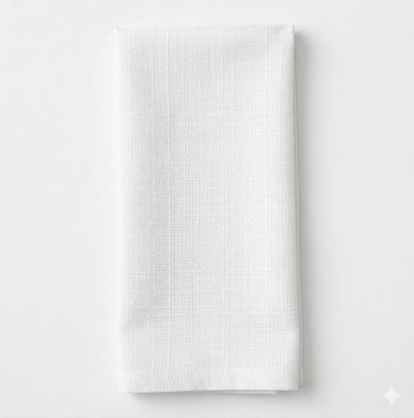 The Amelia White Linen napkin features elegant white linen with a subtle textured pattern, neatly folded on a plain white background—ideal for adding sophistication to any event setting.