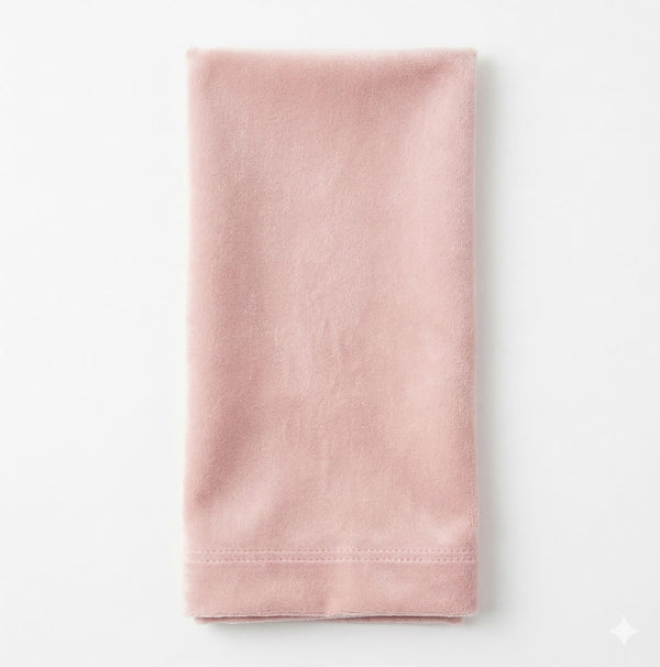 The Charlotte Blush Velvet napkin, neatly folded on a white background, showcases its soft pink velvet texture and finished stitching—perfect for elegant event decor.