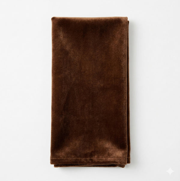 The Charlotte Chocolate Velvet napkin, neatly folded and displayed on a white background, is ideal for adding elegance to any luxurious event decor.