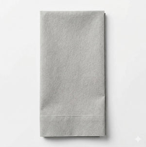 The Charlotte Light Grey Velvet napkin is neatly folded and set on a white background, adding an elegant touch that complements luxurious fabric or sophisticated event décor.