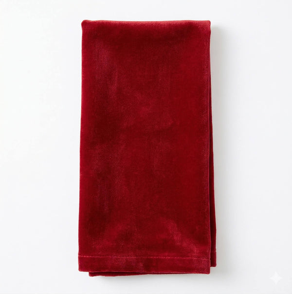 The Charlotte Red Velvet napkin, crafted from luxurious velvet, is neatly folded and displayed on a white background.