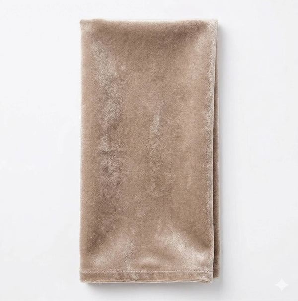 A neatly folded Charlotte Soft Brown Velvet napkin is displayed against a plain white background.