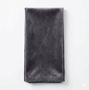 A neatly folded Charlotte Soft Grey Velvet napkin is displayed against a plain white background.