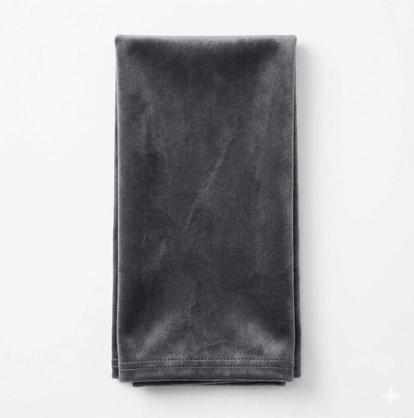 A neatly folded Charlotte Soft Grey Velvet napkin is displayed against a plain white background.