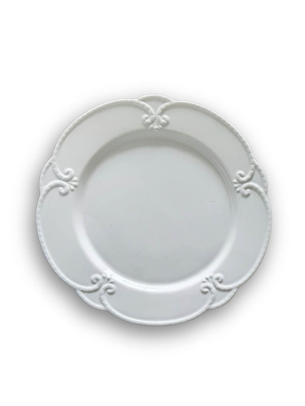 The Annalise White Plate Range features vintage-inspired plates with scalloped edges and decorative embossed patterns around the rim, beautifully displayed against a white background.
