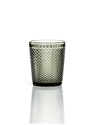 The Apiary Smoke Tumbler is a modern glassware piece with a diamond-patterned, honeycomb-textured surface, shown against a white background and subtle reflection.