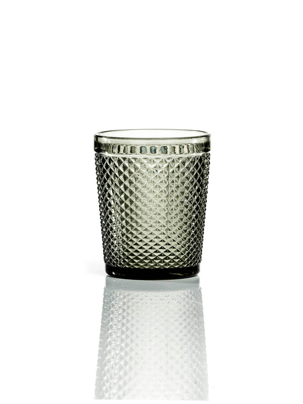 The Apiary Smoke Tumbler is a modern glassware piece with a diamond-patterned, honeycomb-textured surface, shown against a white background and subtle reflection.