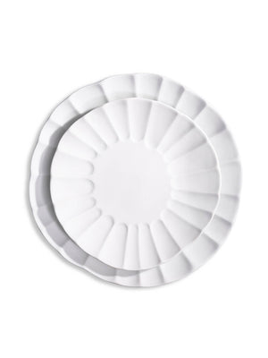 Two white porcelain plates from the Babble Plate Range, one nested inside the other, feature scalloped edges and a petal-like rim design—a refined choice for elegant dining.