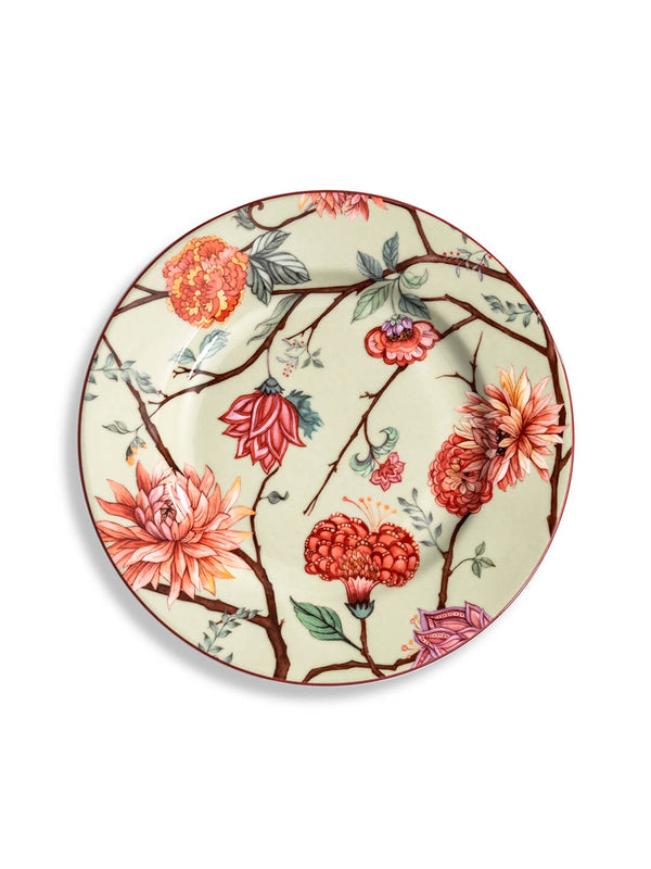 The Botanic Green Plate Range features a round ceramic plate with a cream background, adorned with large, colorful red, orange, and pink flowers plus brown branches for a vibrant, nature-inspired tableware accent.