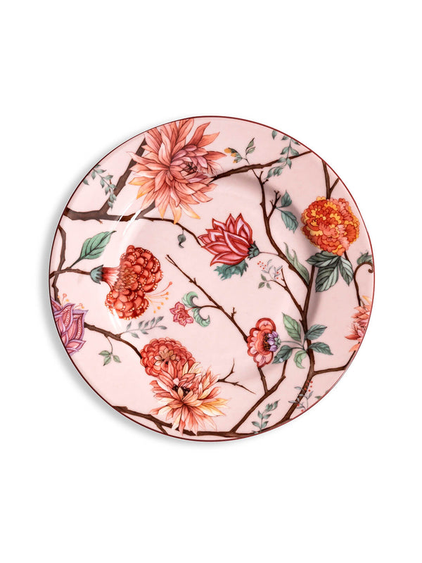A round ceramic plate from the Botanic Pink Plate Range, featuring a pale pink background with a colorful floral design of red, orange, and pink flowers, green leaves, and brown branches.