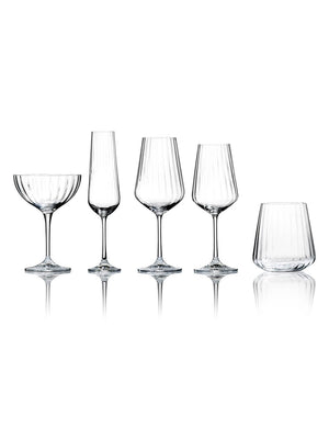 The Catherine Glassware Range includes five clear, empty pieces—a coupe, flute, two wine glasses, and a tumbler—each with a subtle ripple pattern, elegantly displayed on a white background for luxury weddings.