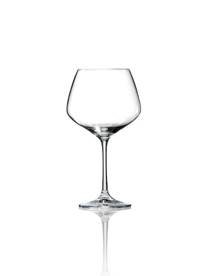 The Classic Gin Glass, featuring a thin stem and wide bowl, stands upright on a reflective white surface against a plain white background—ideal for luxury entertaining.