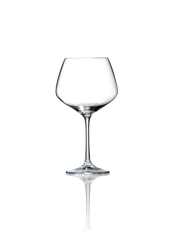The Classic Gin Glass, featuring a thin stem and wide bowl, stands upright on a reflective white surface against a plain white background—ideal for luxury entertaining.