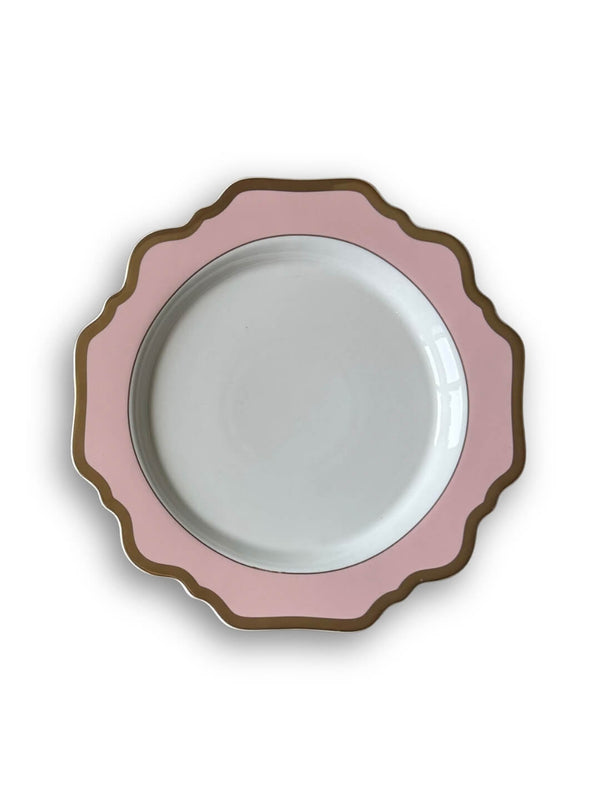 An overhead view of a round white plate from the Colette Pink Plate Range, featuring a pink scalloped border and gold trim—a refined addition to luxury tableware.