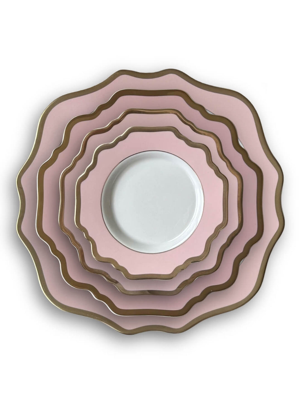 Five Colette Pink plates in graduating sizes, stacked neatly. Each luxury plate has pink and gold trim, except the smallest, which features a white center with a pink and gold scalloped rim. All are viewed from above.
