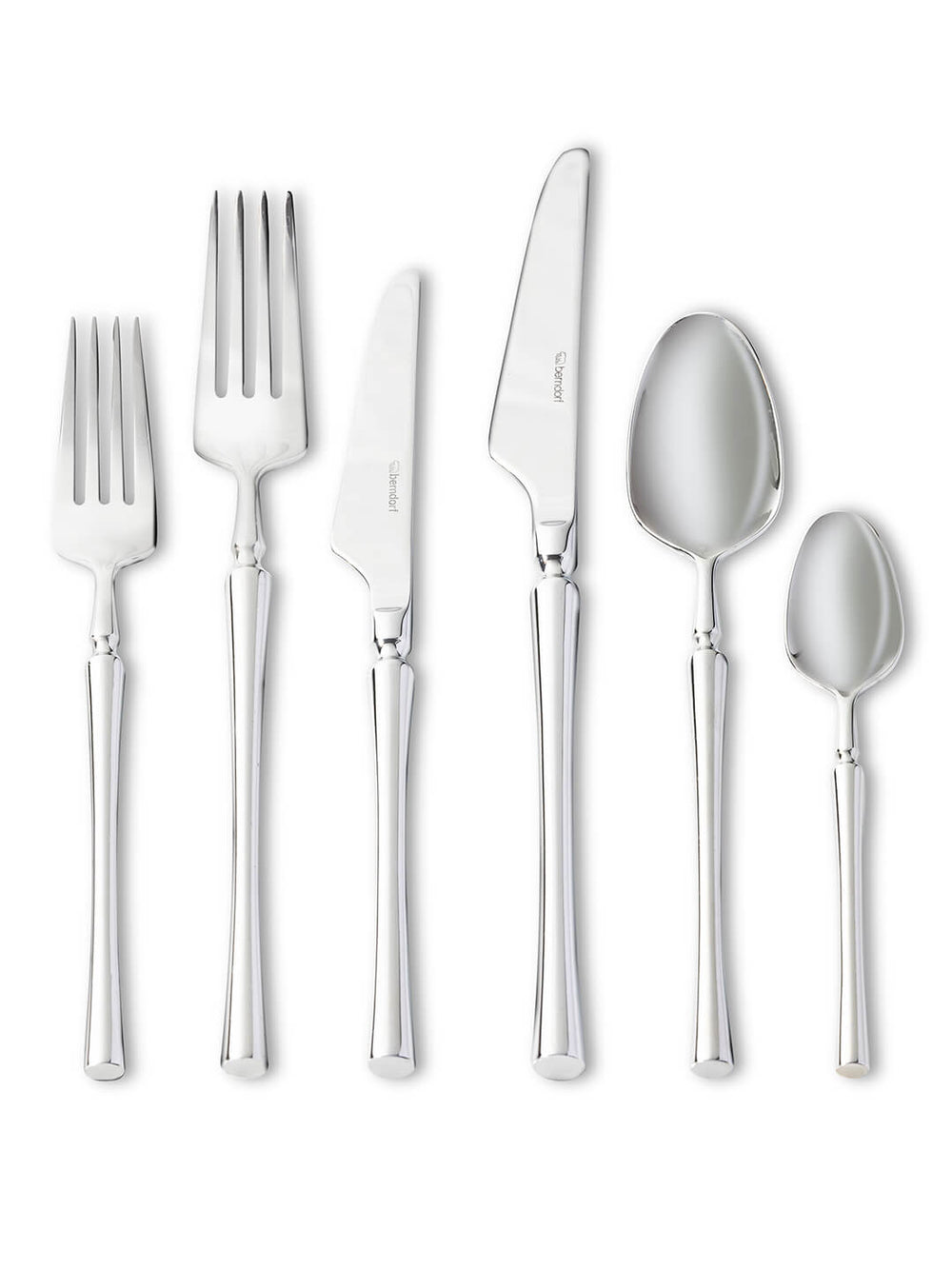 Six polished stainless steel pieces from the Emre Cutlery Range‚Äîsalad fork, dinner fork, butter knife, dinner knife, tablespoon, and teaspoon‚Äîare arranged upright in a row on a white background.