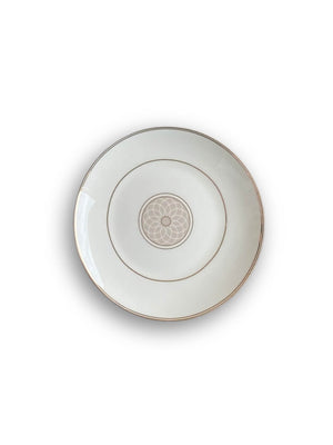 An elegant white ceramic plate from the Grace Plate Range, featuring a thin gold rim and a light beige geometric floral center pattern, displayed on a white background—modern dinnerware at its finest.