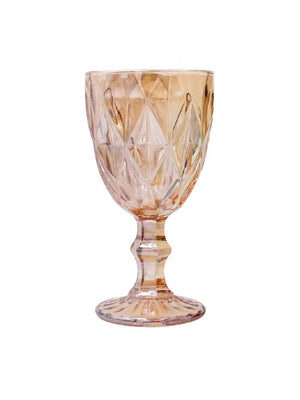 The Hilda Peach Water Glass features a faceted diamond pattern and pink tint on a sturdy stem, making it perfect for adding charm to wedding table decor.