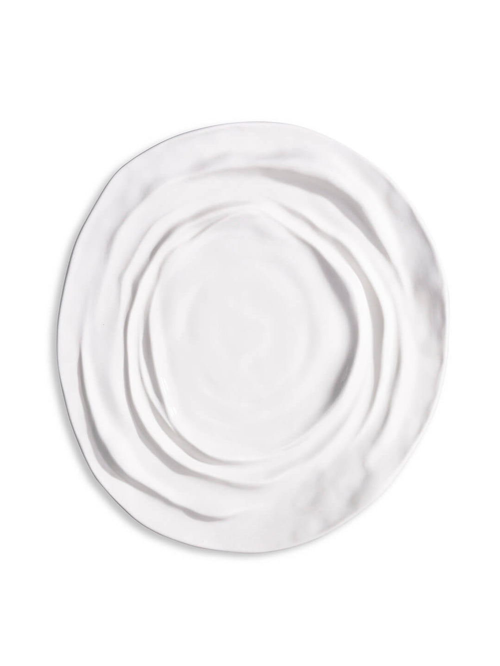 The Lavina Plate is a white ceramic plate with an irregular, wavy textured surface and uneven edges—an elegant piece for any luxury dinnerware collection.
