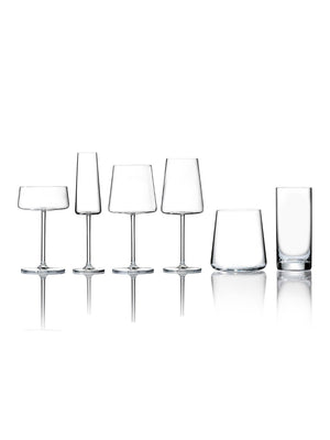 A row of six clear, empty glasses from the Lola Glassware Range—featuring wine, cocktail, and tumbler styles—is elegantly arranged on a reflective white surface.