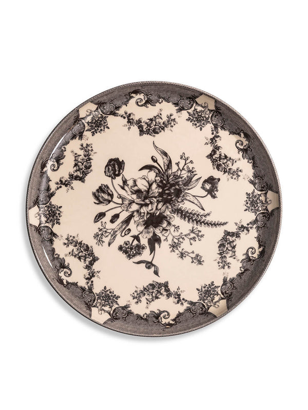 The Lucinda Black Plate Range features round ceramic plates with a cream background, ornate black floral designs, and decorative rims—ideal for vintage-inspired dinnerware or adding elegance to modern tablescapes.