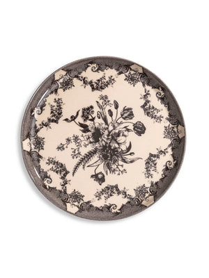 The Lucinda Black Plate Range features round ceramic plates with vintage-inspired black floral patterns and ornate scrollwork on a cream background—perfect for adding timeless elegance to modern tablescapes.
