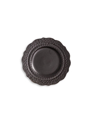 A dark gray plate from the Noir Plate Range, featuring scalloped edges and embossed patterns, displayed from above on a white background.
