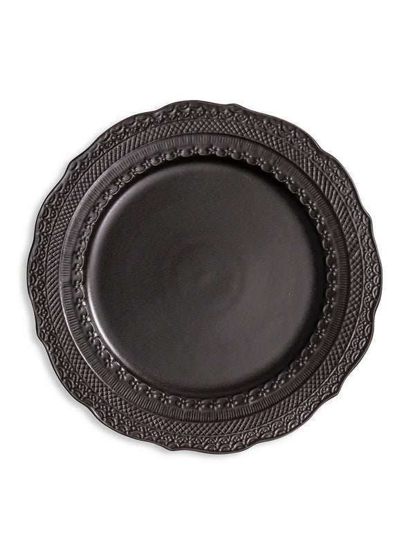 A round, matte black plate from the Noir Plate Range features an ornate, embossed rim and is shown from above on a white background—bringing elegance to your table with this stylish dinnerware.