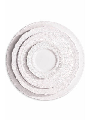 The Opaline Plate Range includes four ivory-white charger plates in graduating sizes, featuring embossed patterns and scalloped edges—ideal for creating an elegant table setting.