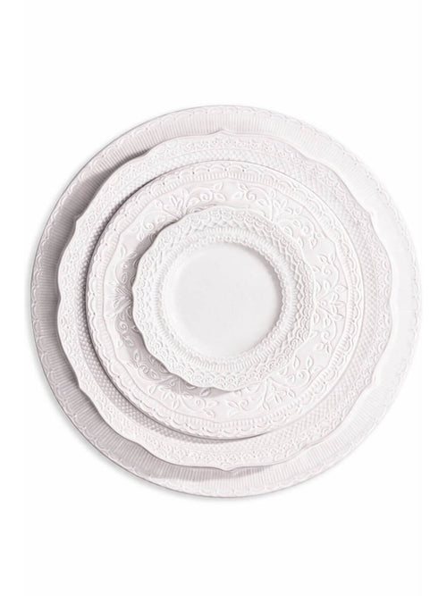 The Opaline Plate Range includes four ivory-white charger plates in graduating sizes, featuring embossed patterns and scalloped edges—ideal for creating an elegant table setting.