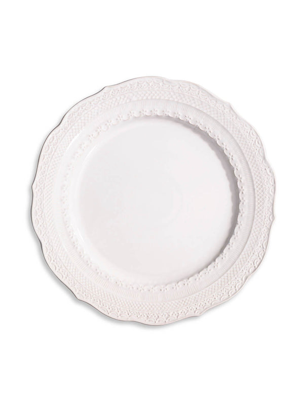 The Opaline Plate Range features a white ceramic charger with an ornate, embossed rim and a glossy center, shown from above—ideal for adding elegance to any table setting.