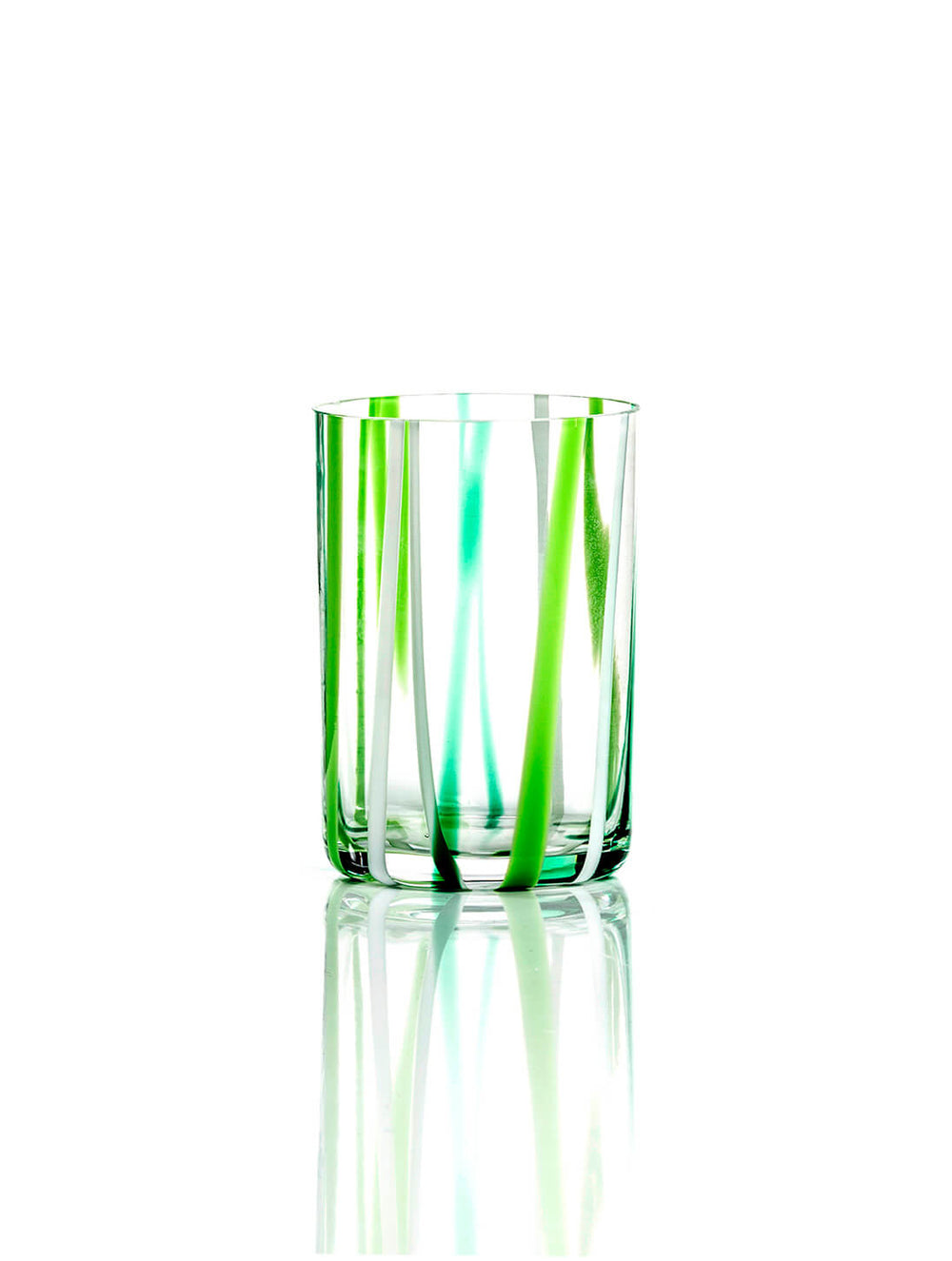 The Reed Green Tumbler features vertical green and turquoise stripes, offering modern artistic glassware style. It stands out with its vibrant look and simple elegance on any reflective white surface.