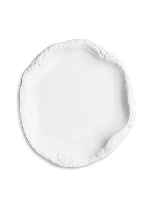 A white ceramic plate from the Rocca Plate Range, featuring an irregular textured rim and glossy center, viewed from above on a plain background—an elegant piece for luxury tableware and fine dining.