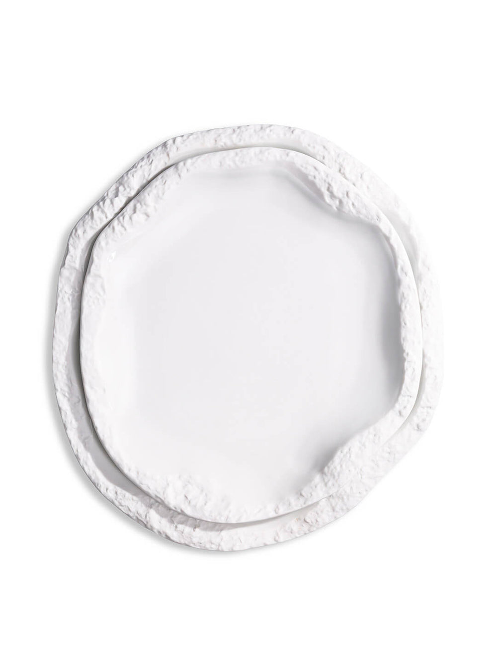 A white, round ceramic plate from the Rocca Plate Range, featuring an irregular textured and layered edge, is displayed against a plain white background as part of a luxury fine dining collection.