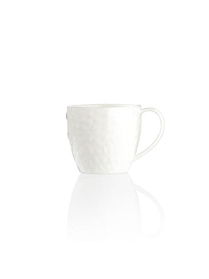 A white ceramic mug with a textured surface and handle from the Sky Plate Range, set on a plain white background with a subtle reflection, is an ideal addition to modern dinnerware collections.