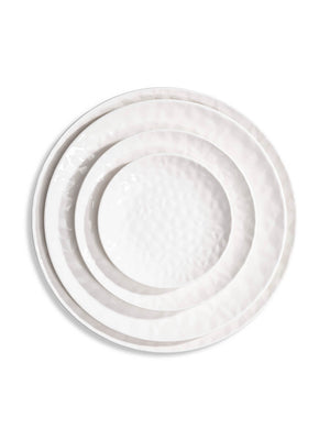 Three white ceramic plates from the Sky Plate Range, each a different size with a subtle hammered texture, are stacked concentrically on a white background.