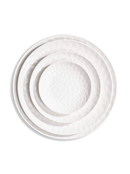 Three white ceramic plates from the Sky Plate Range, each a different size with a subtle hammered texture, are stacked concentrically on a white background.
