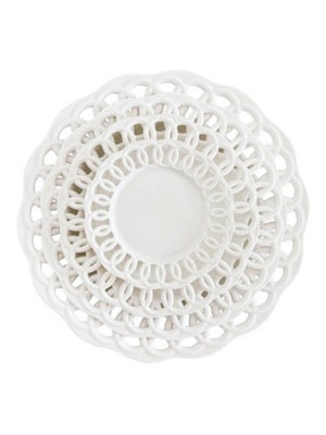 Four stacked Sol Plate Range dishes in white, each a different size, feature openwork lace-like edges. Viewed from above, the layered circles create a modern, elegant design.