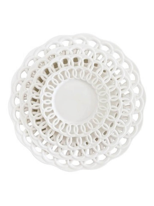 Four stacked Sol Plate Range dishes in white, each a different size, feature openwork lace-like edges. Viewed from above, the layered circles create a modern, elegant design.