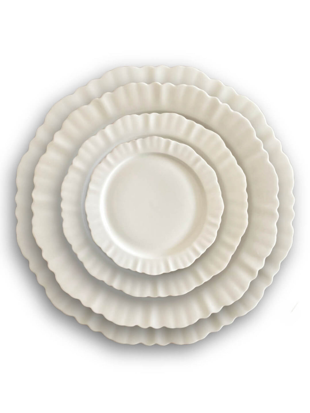 Four white plates from the Sophia Plate Range, featuring ruffled edges, are stacked from largest to smallest and viewed from above against a white background—showcasing elegant dinnerware design.