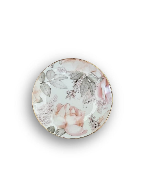 The Vera Plate Range features a round porcelain plate with soft pink roses and light green leaves on a white background, adding elegant, garden-inspired charm to any table setting.