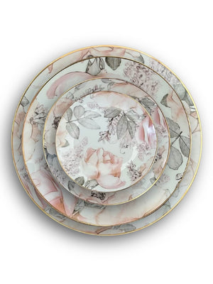 The Vera Plate Range features four round porcelain plates, stacked by size, with pastel pink rose and green leaf patterns and finished with a gold rim—perfect for elegant, garden-inspired table settings.